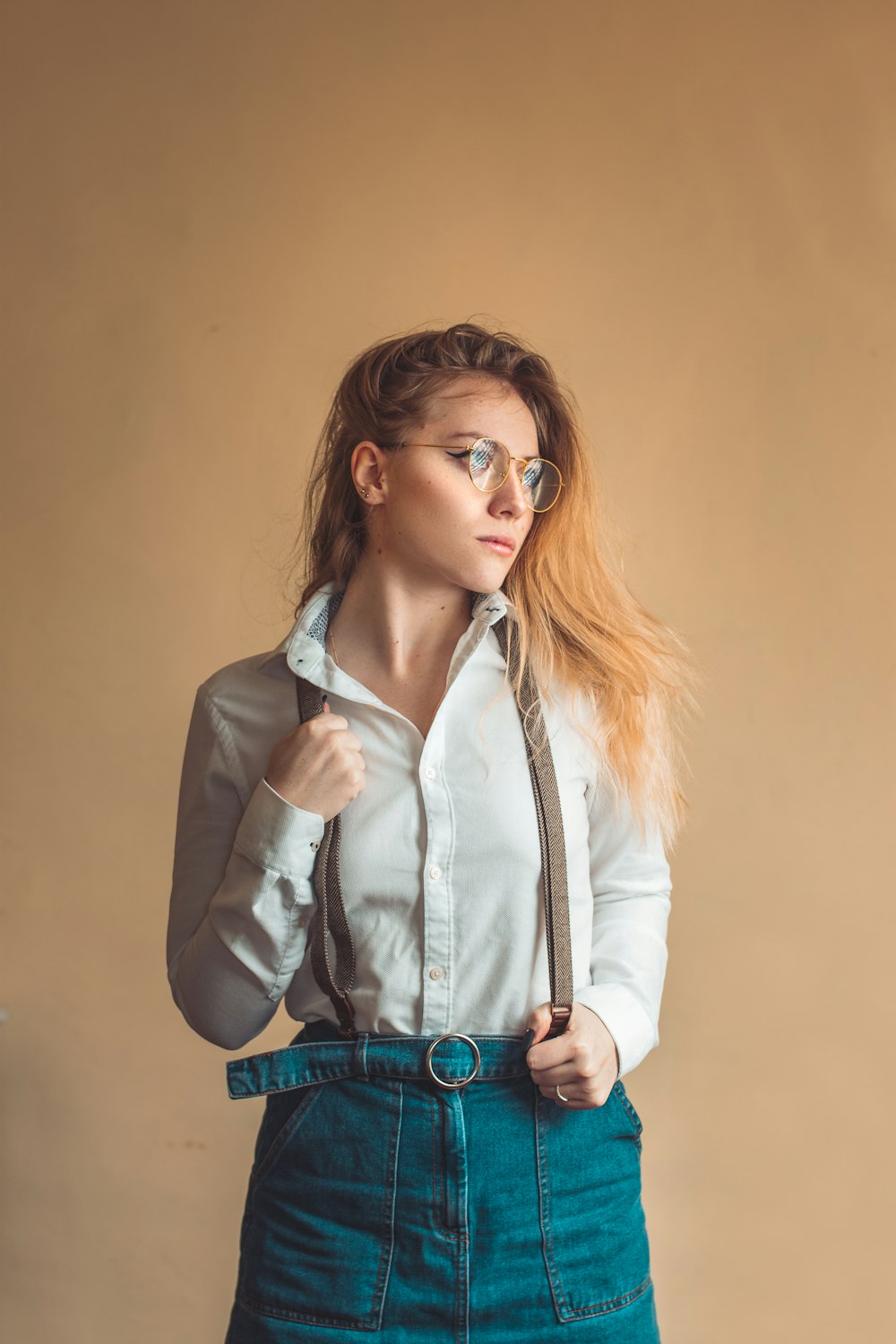 woman in white button up long sleeve shirt and blue denim jeans