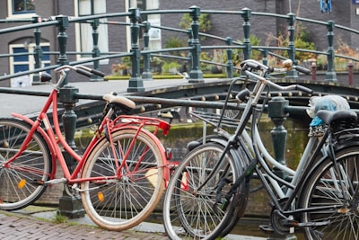 Bicycles resting against a canal railing, ready for a personalized slow-tour through hidden city gems.