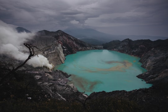 lake in the middle of mountains during daytime in Ijen Indonesia
