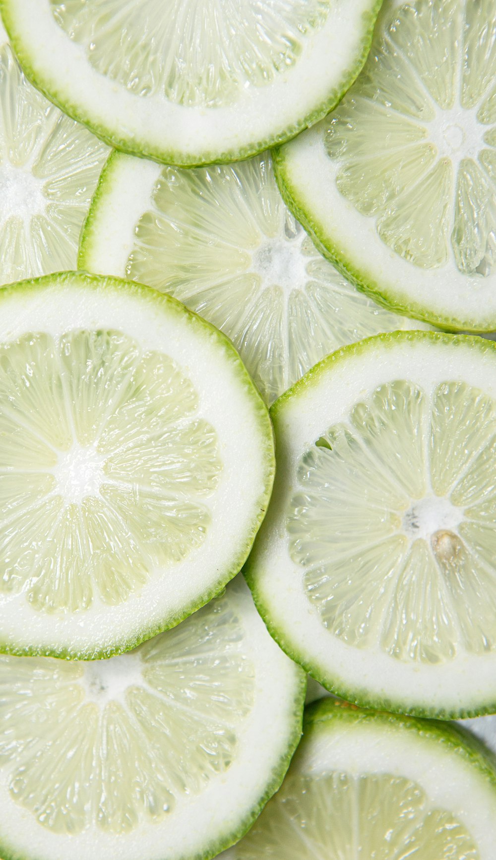 sliced green lime on brown wooden table