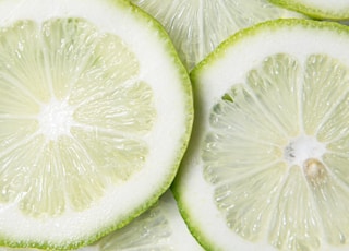 sliced green lime on brown wooden table