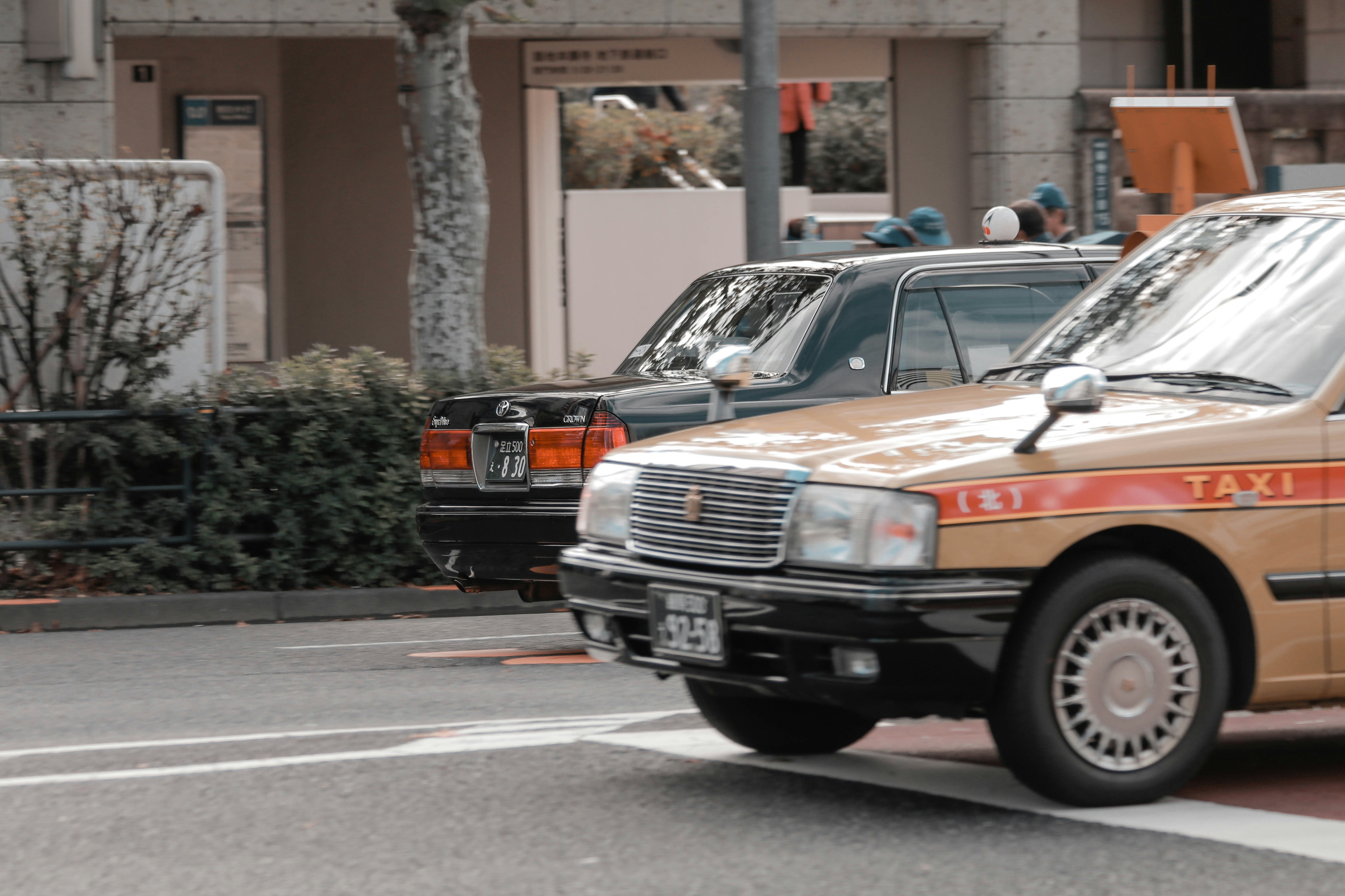 red and black car on road during daytime