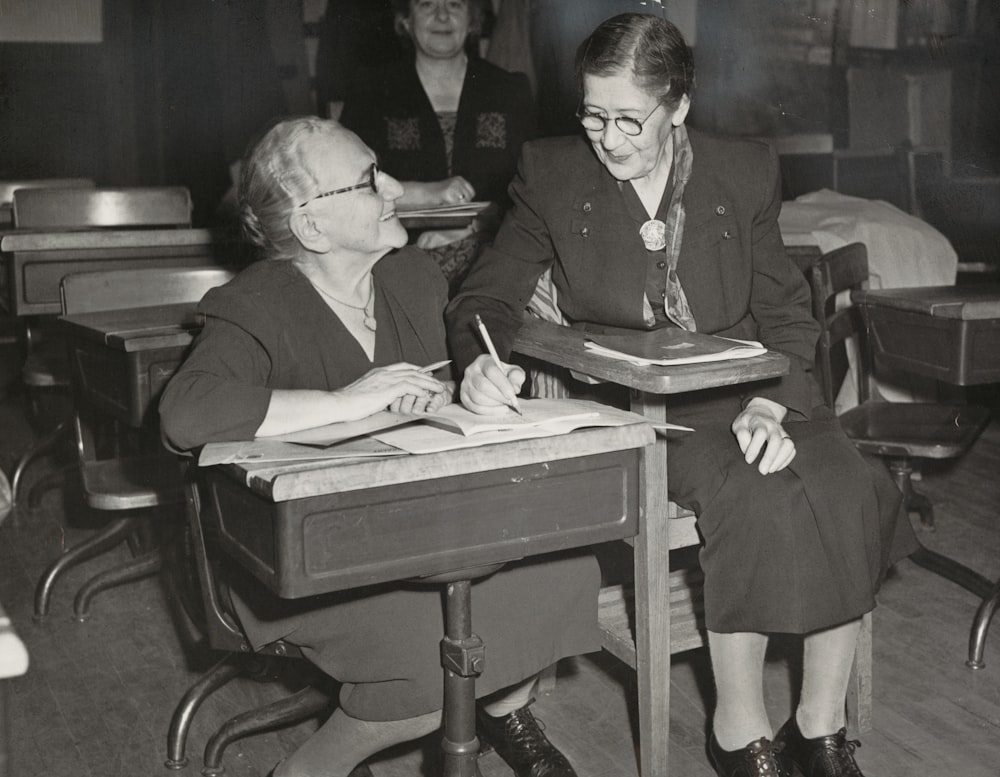 man and woman sitting on chair