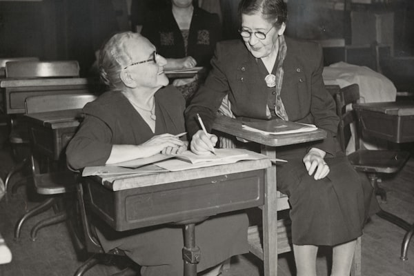 Teacher and student sitting on a chair