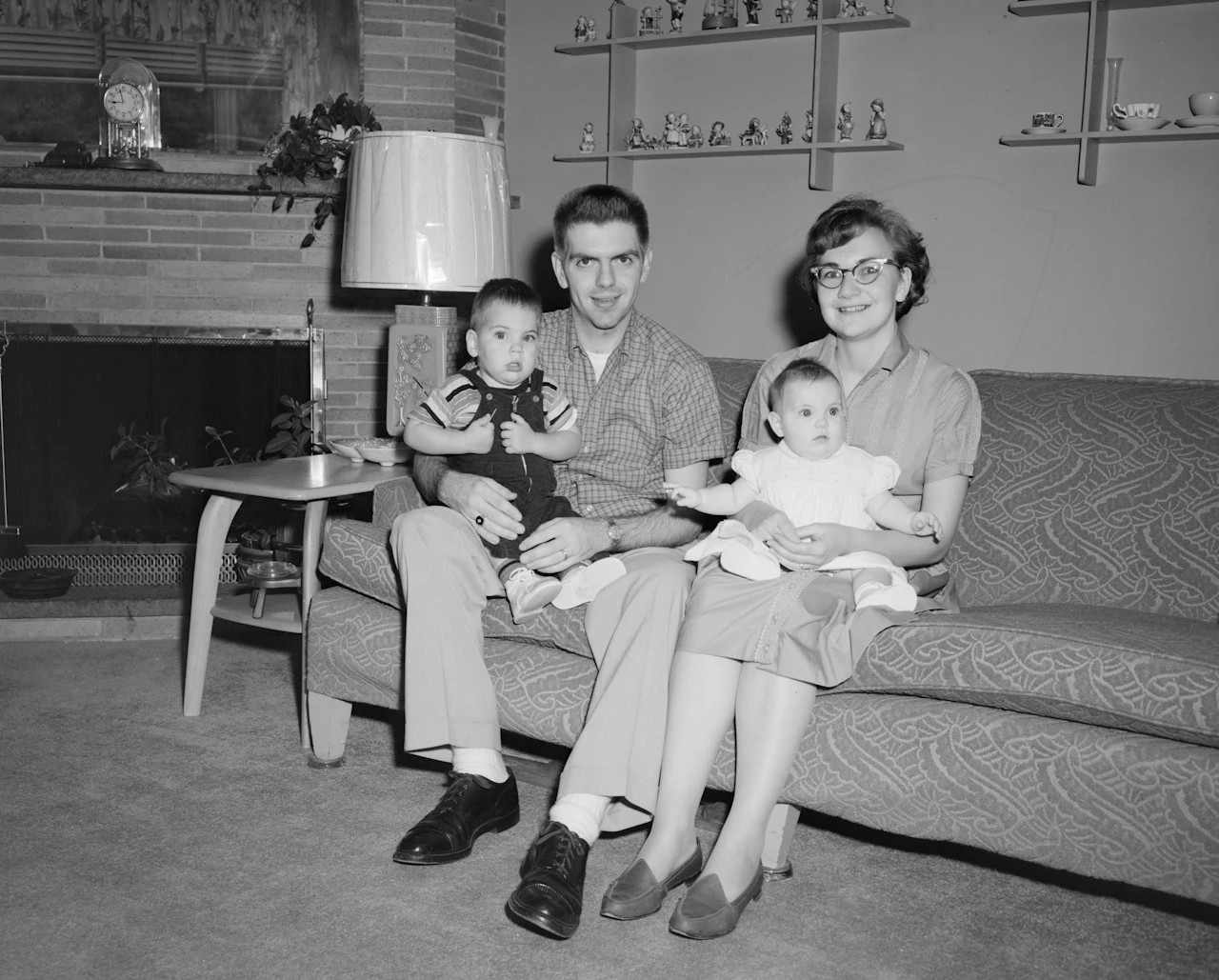 Grayscale photo of 2 boys sitting on couch
