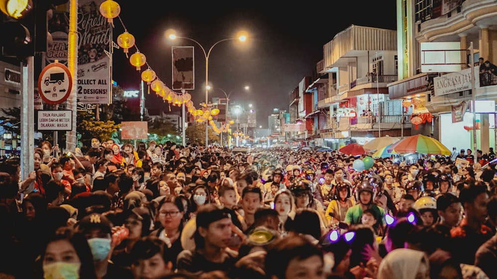 people gathering on street during night time