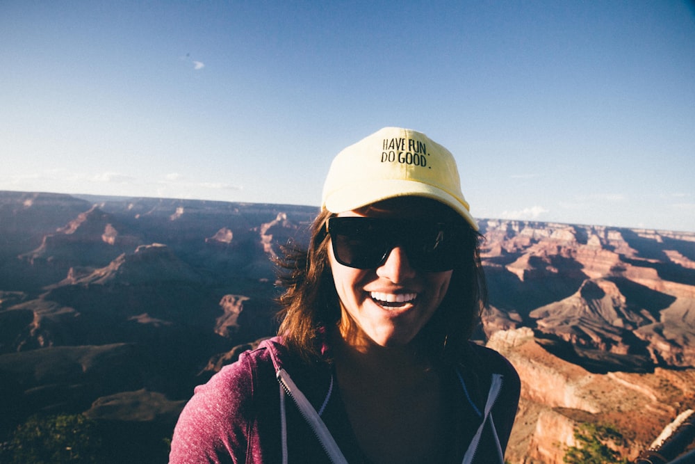 woman in purple hoodie wearing white and blue cap