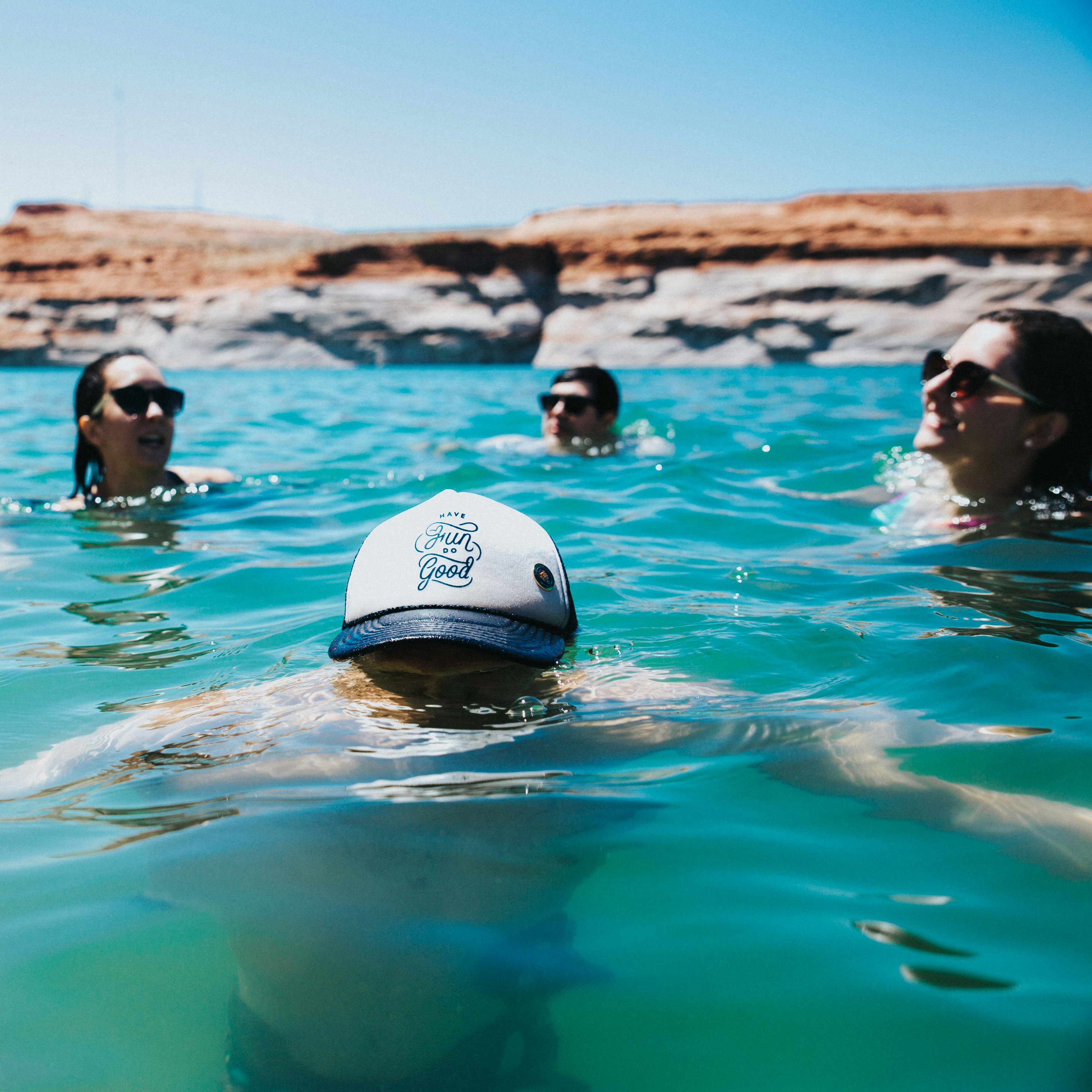 woman in white and black swimming cap in water during daytime