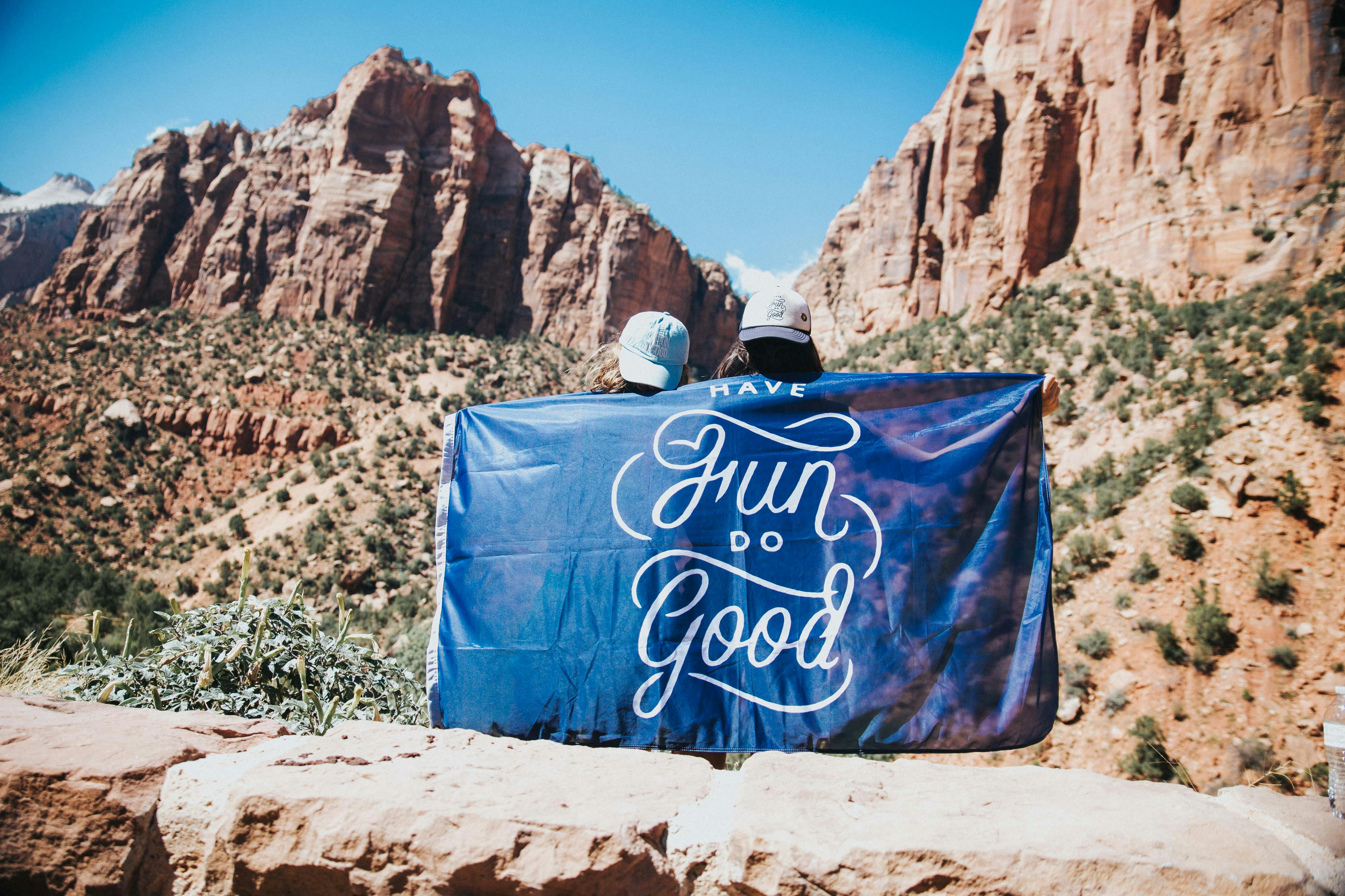 blue and white tote bag on brown sand during daytime