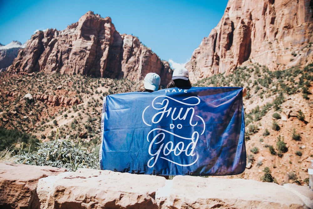 blue and white tote bag on brown sand during daytime