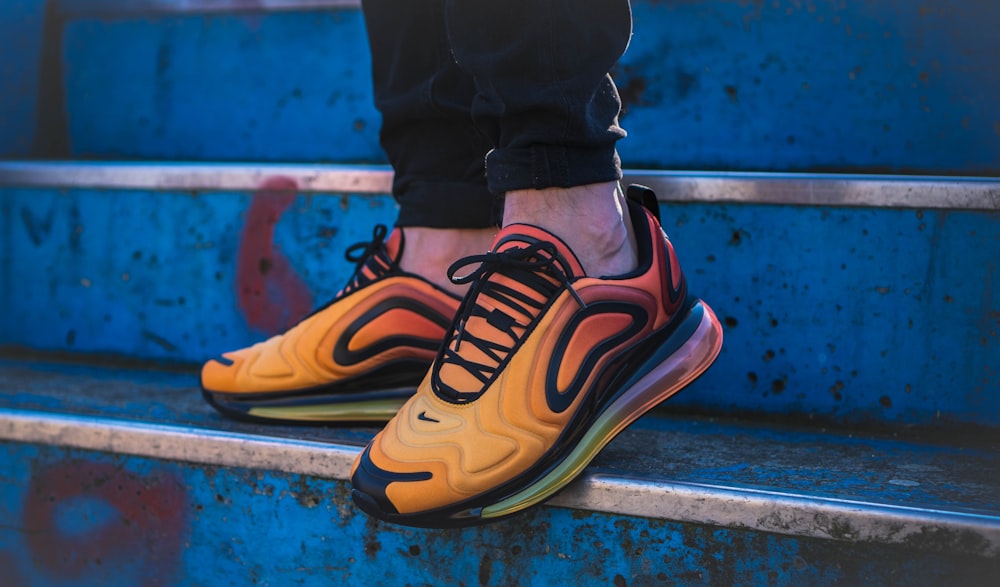 Person wearing yellow and black nike sneakers photo – Free Deutschland  Image on Unsplash