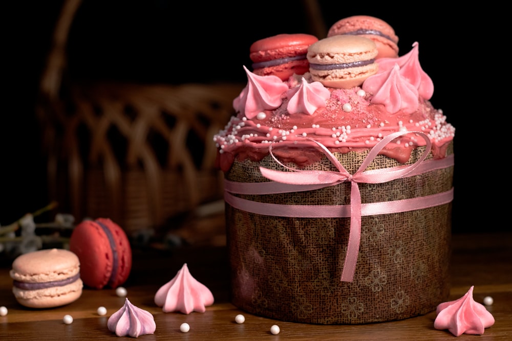 chocolate cake with pink and white ribbon on brown wooden table