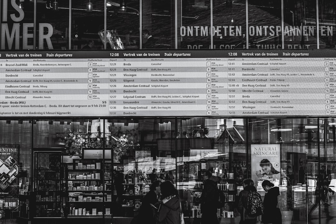 grayscale photo of people in front of store