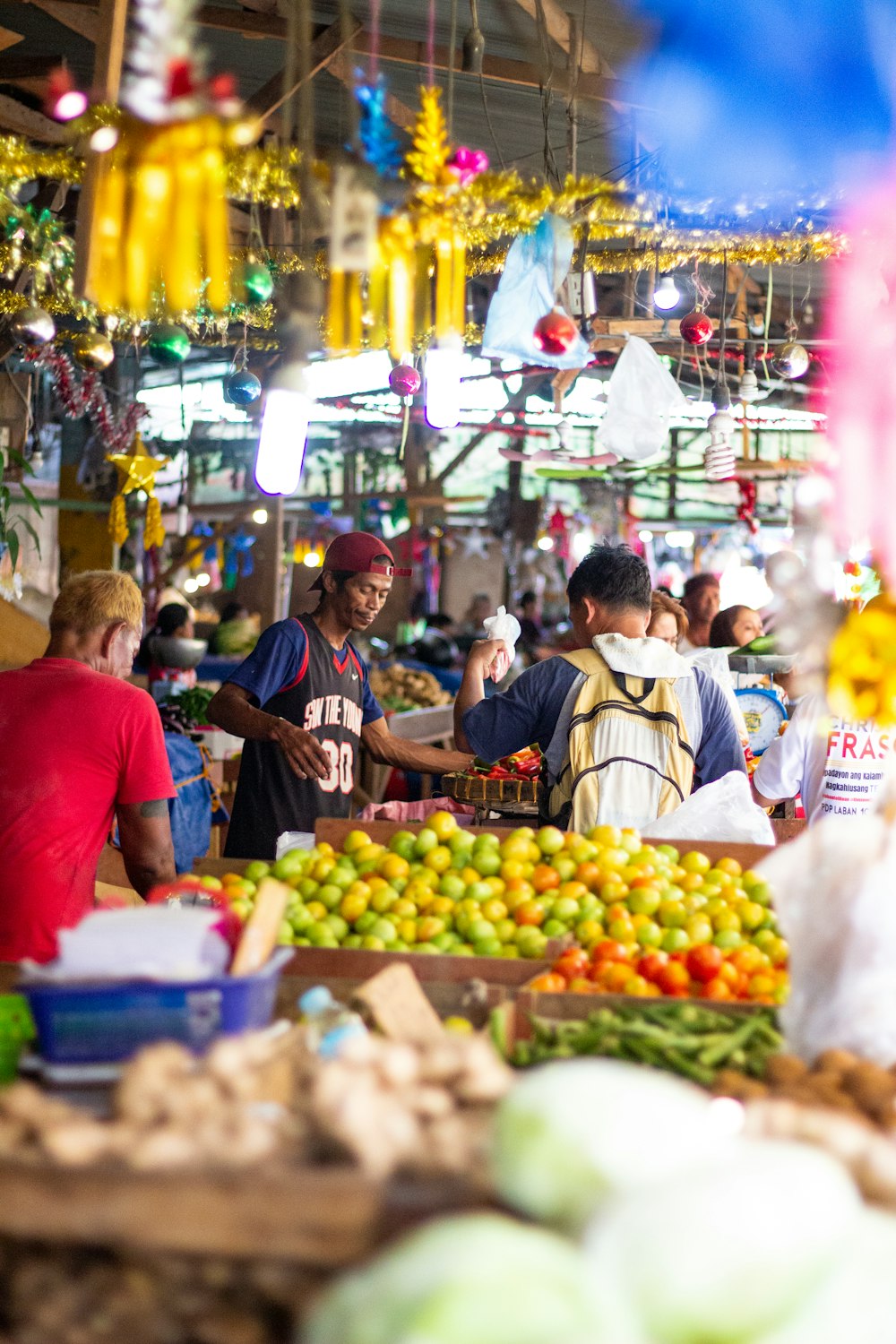 people standing near fruit stand during daytime