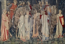 people in brown traditional dress standing on green grass during daytime