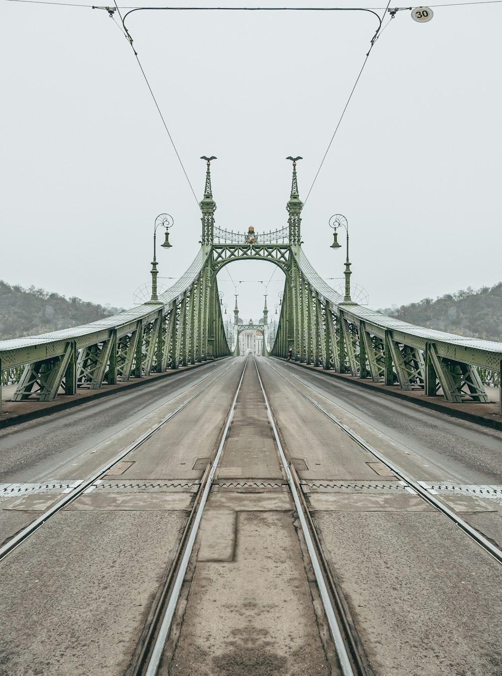 green metal bridge under white sky during daytime