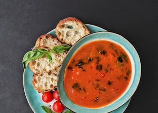 tomato soup in white ceramic bowl