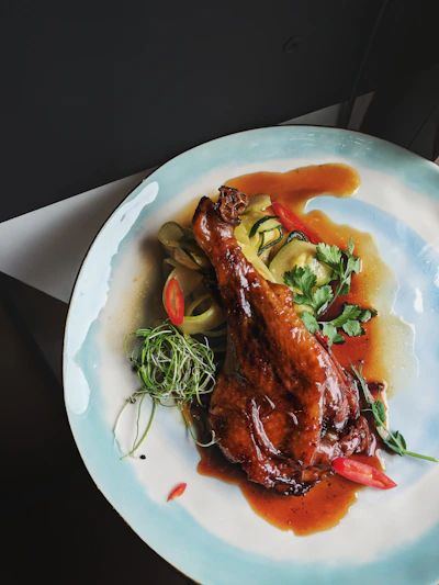 Close-up of Golden Ginger's signature crispy duck with vibrant Asian spices, beautifully plated.