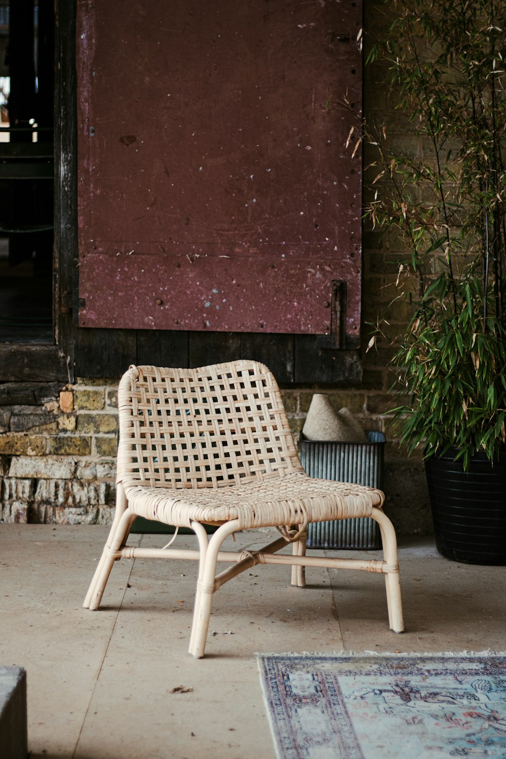 white and black polka dot chair beside red wall