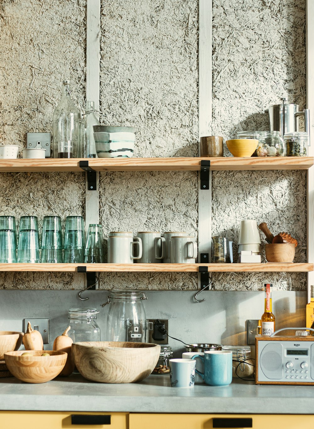 clear glass jars on brown wooden shelf