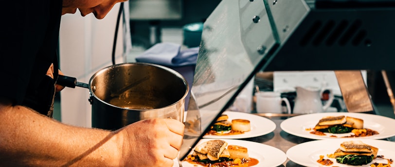 man in black t-shirt holding stainless steel bowl