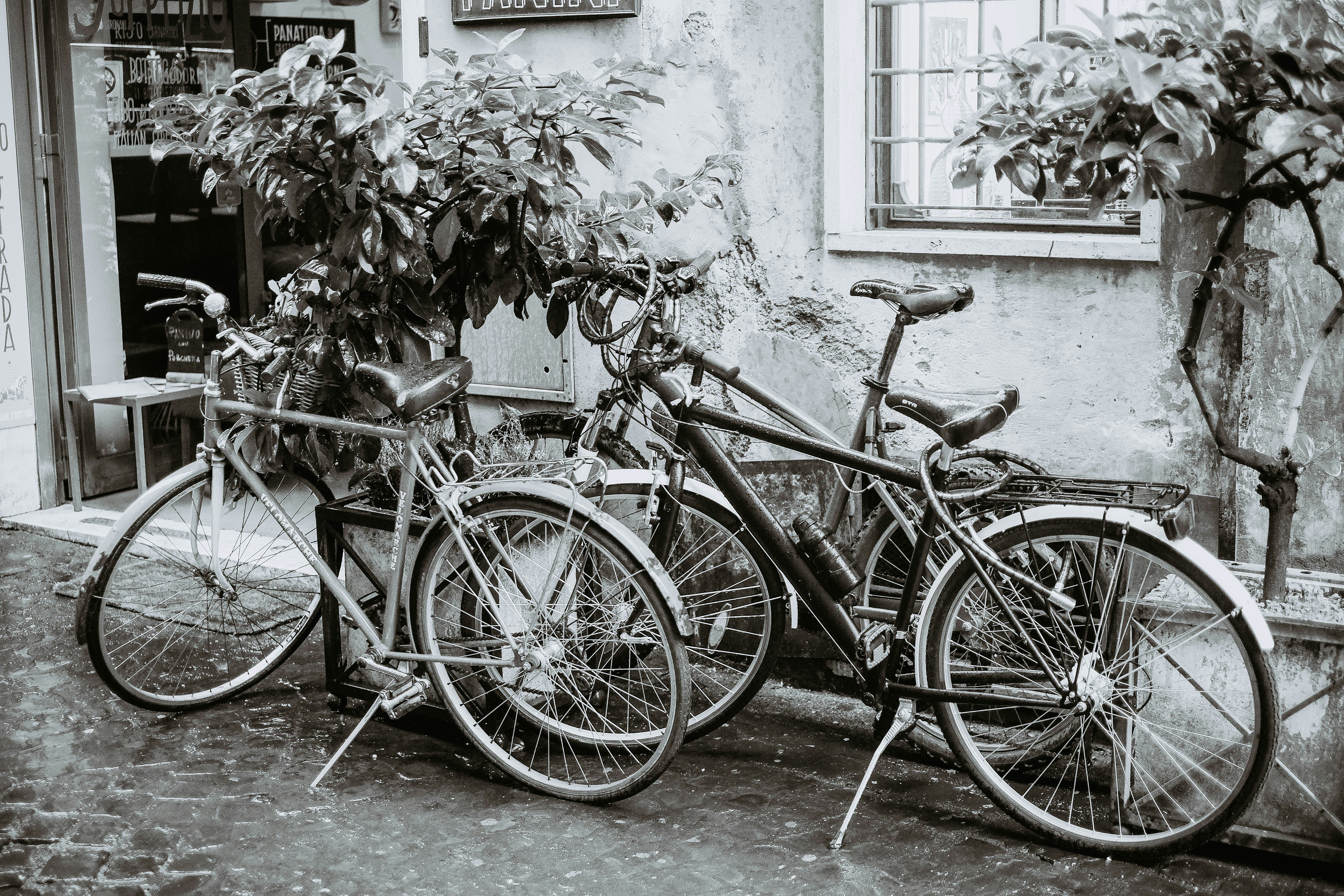 black commuter bike parked beside white wall