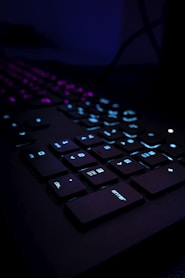 black computer keyboard on blue textile