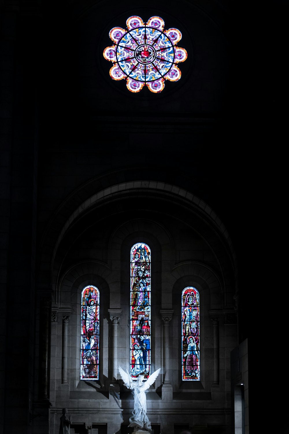 a large stained glass window inside of a church