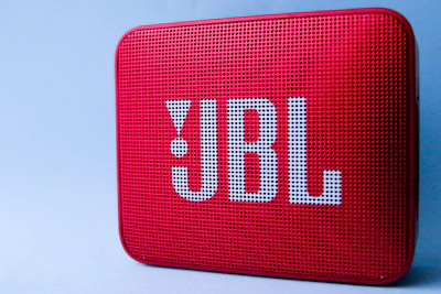 A vibrant, portable Bluetooth speaker with colorful LED lights in action.