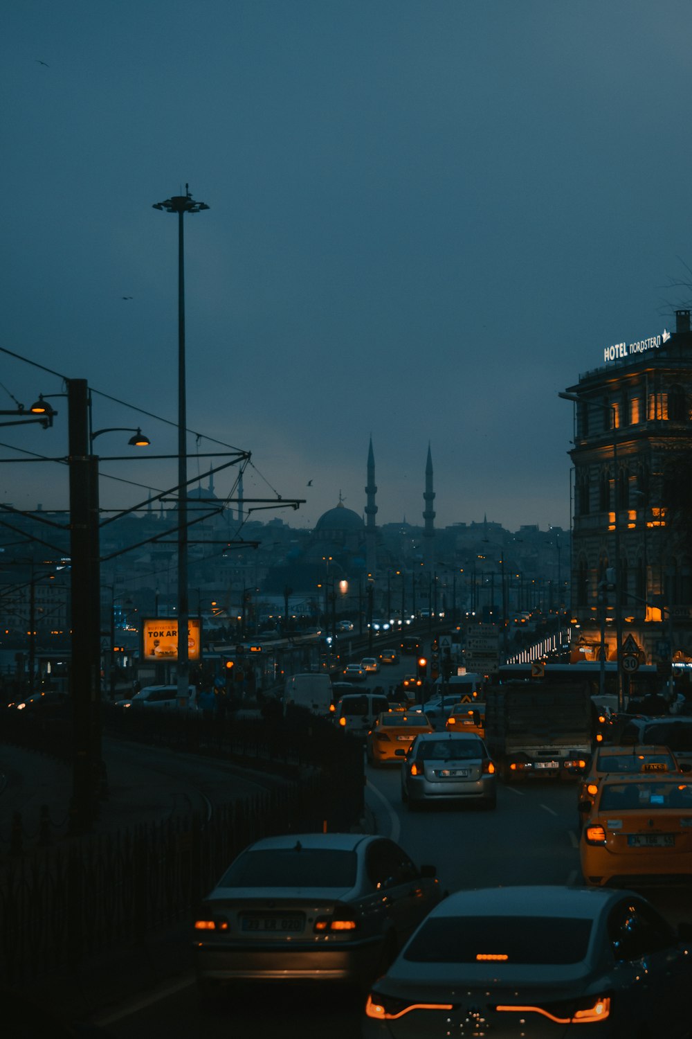 cars on road near city buildings during night time