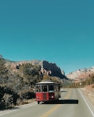 red and black bus on road during daytime