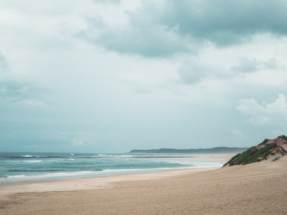 blue sea under white clouds during daytime