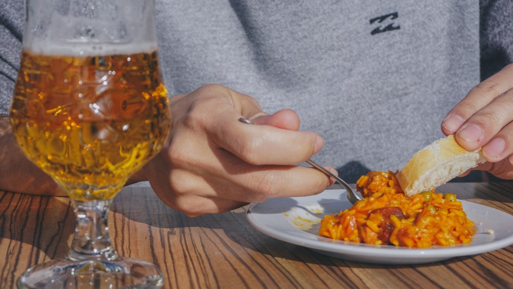 person holding stainless steel fork and knife