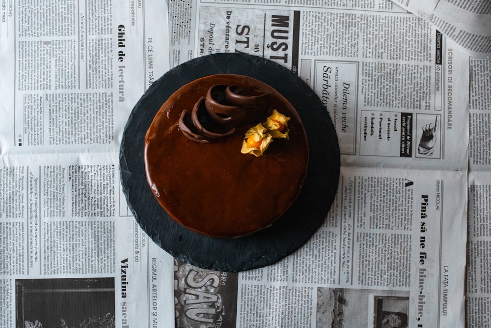 brown round plate on white newspaper