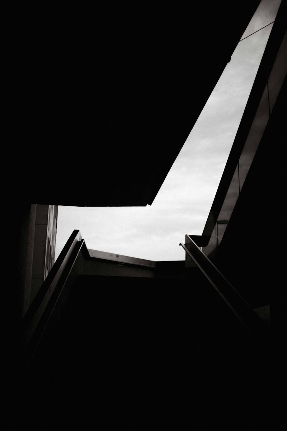 low angle photography of concrete building under white clouds during daytime