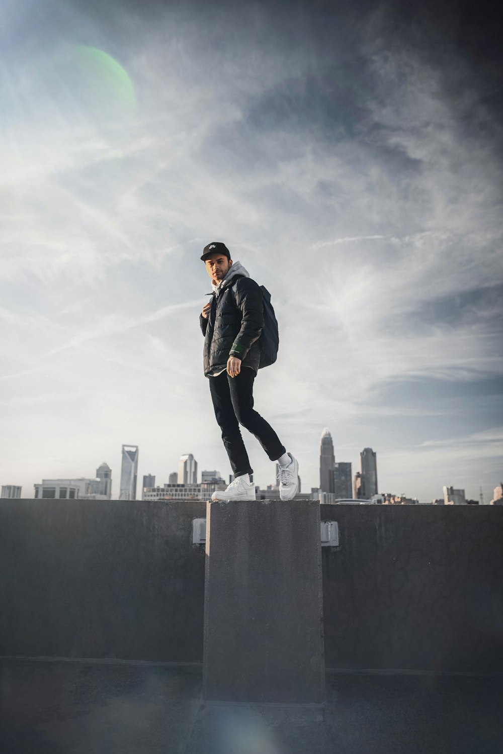 man in black jacket standing on top of building during daytime