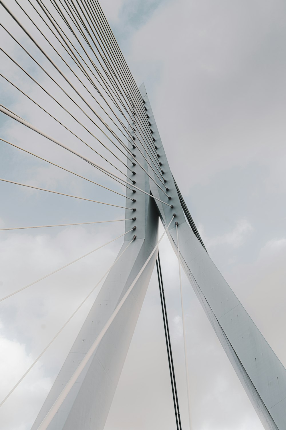 white bridge under white clouds