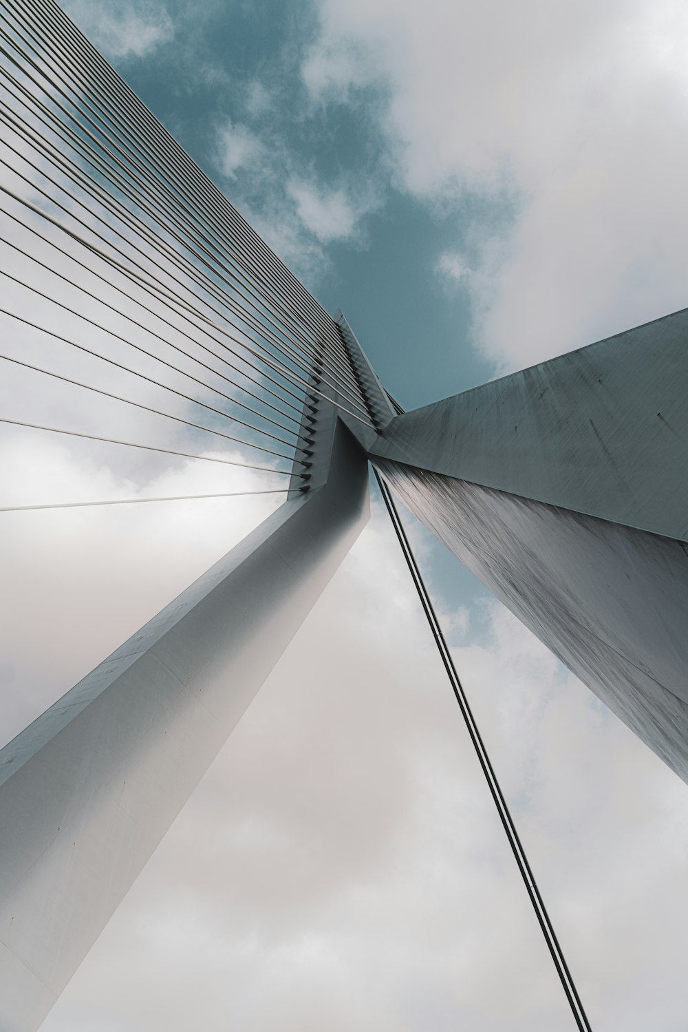 low angle photography of gray concrete building under cloudy sky during daytime