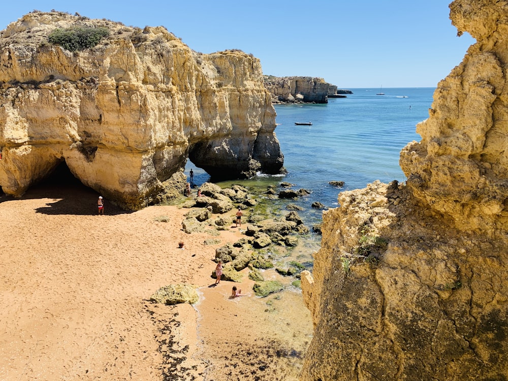 brown rock formation near body of water during daytime