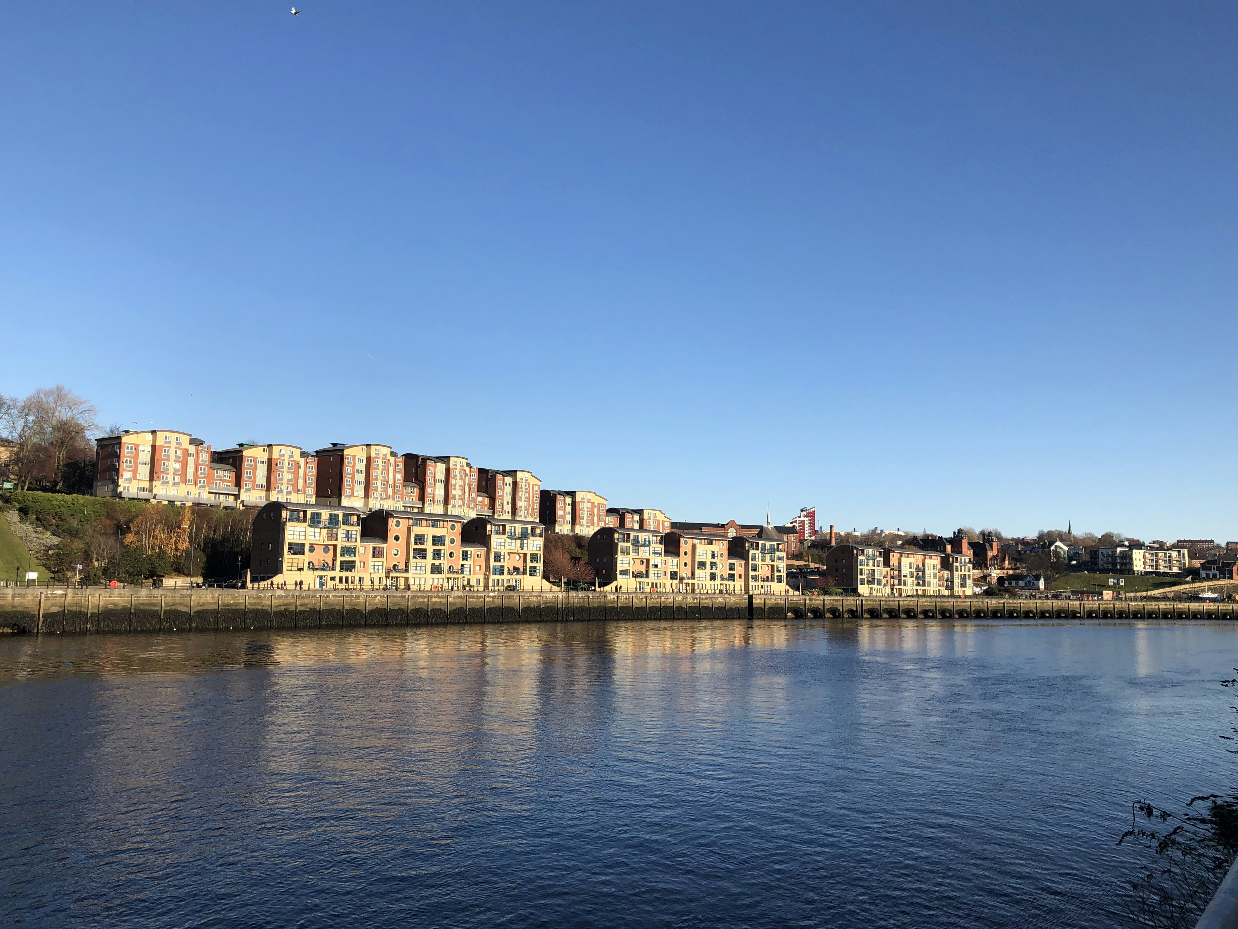 brown concrete building near body of water during daytime