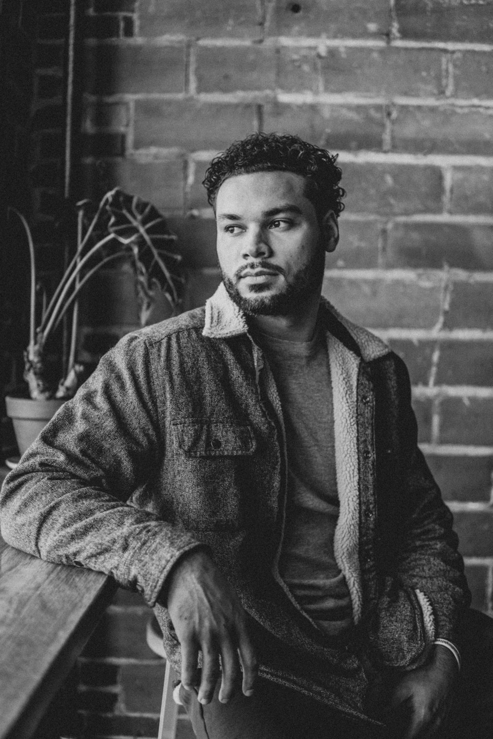 grayscale photo of man in zip up jacket