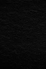Close-up of a velvet fabric texture in deep black, symbolizing luxury.