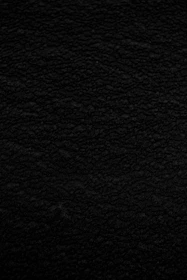 Close-up of a velvet fabric texture in deep black, symbolizing luxury.