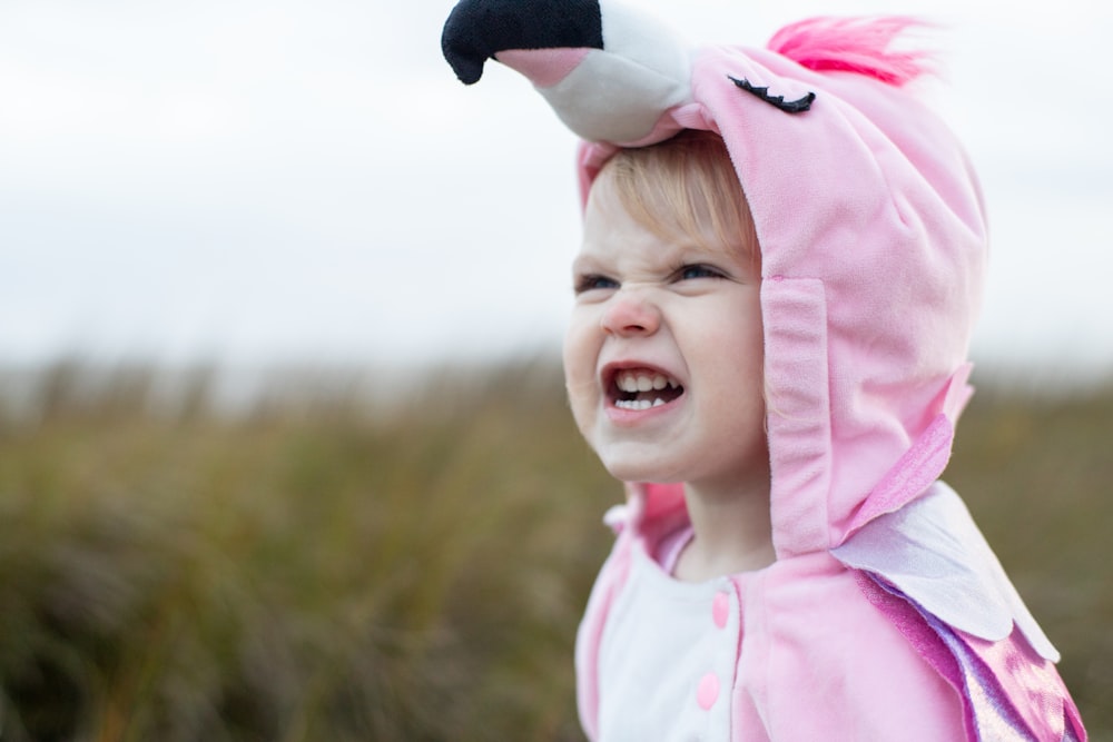 girl in pink and white polka dot hoodie smiling