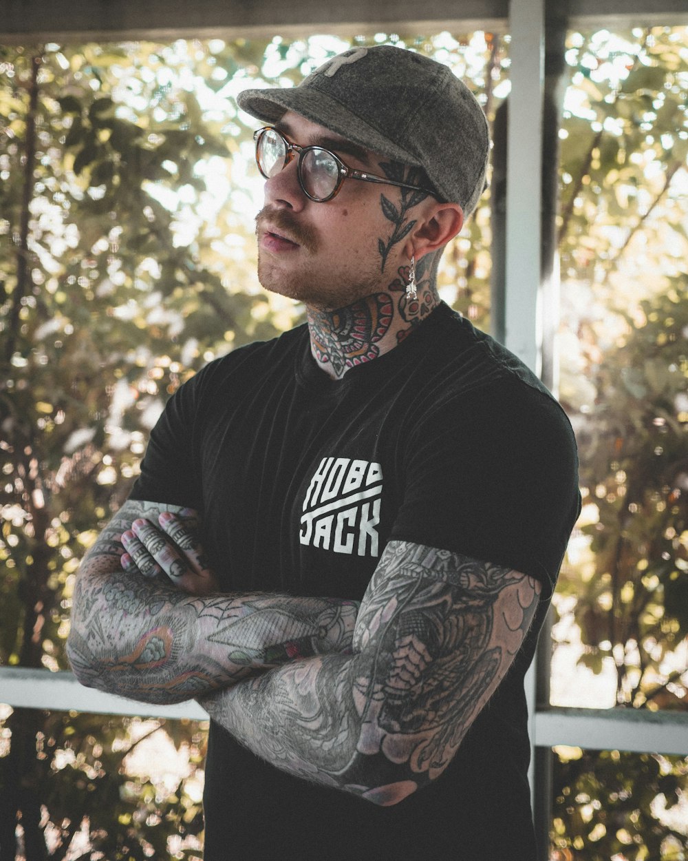 man in black crew neck t-shirt wearing black framed eyeglasses