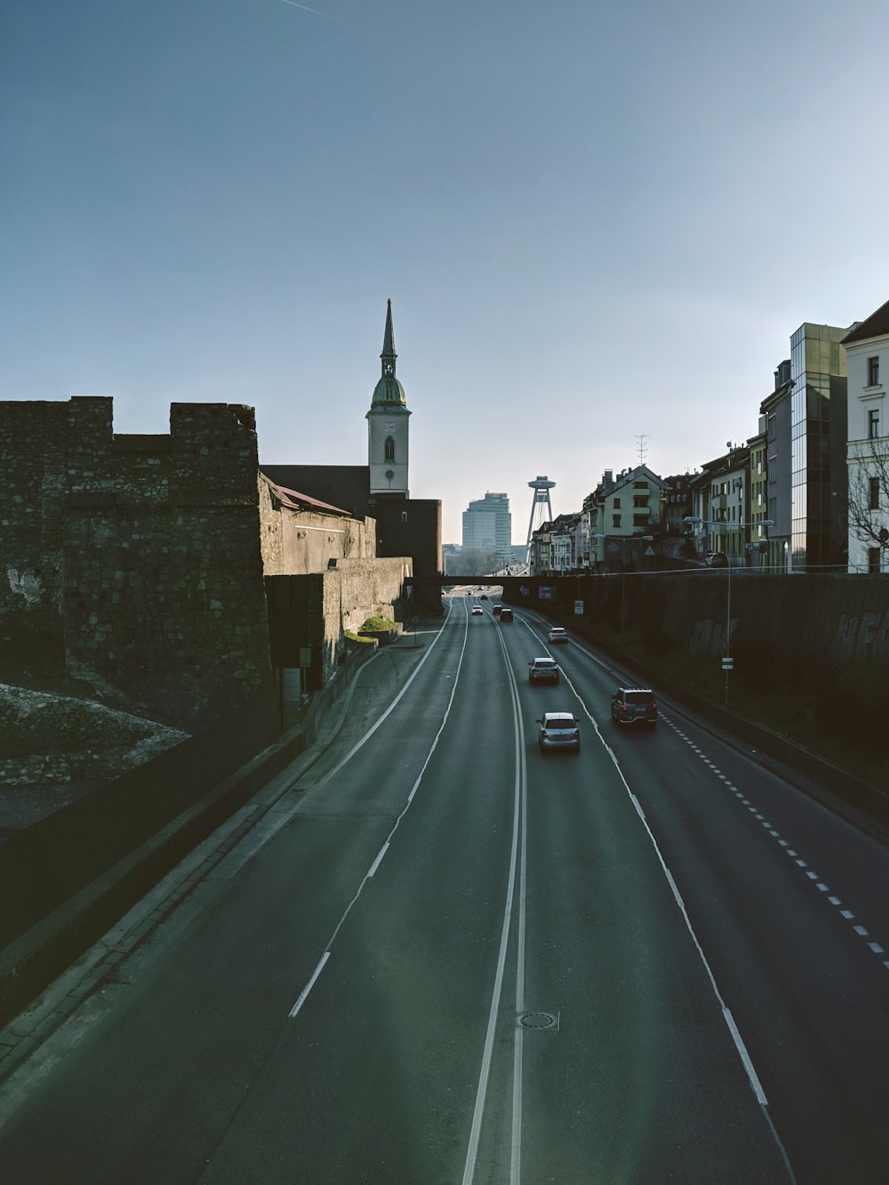 black car on road near brown concrete building during daytime