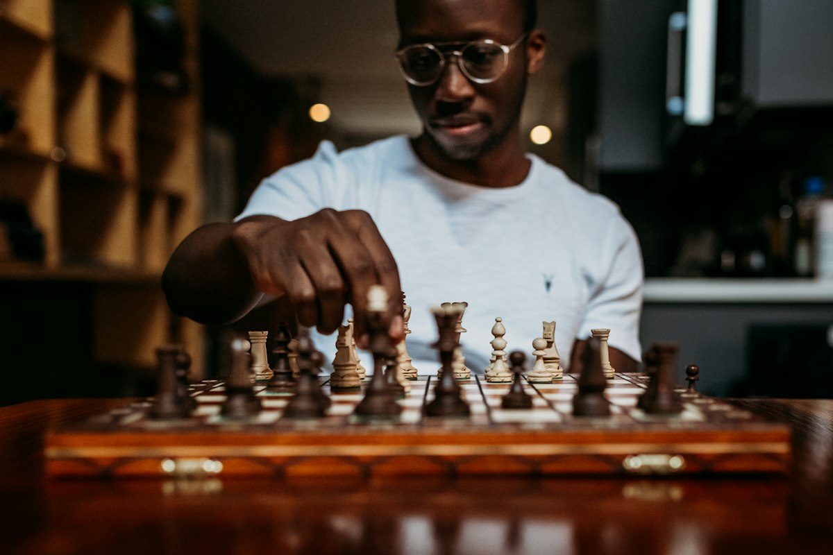 Radio host thinking through his next move at a chessboard