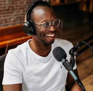 man in white crew neck t-shirt wearing black framed eyeglasses