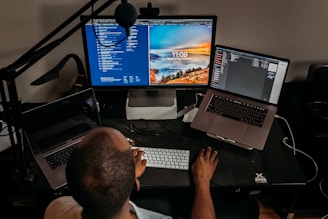man in blue shirt using computer