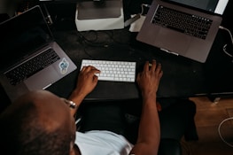 A professional working remotely with multiple cloud storage devices around.